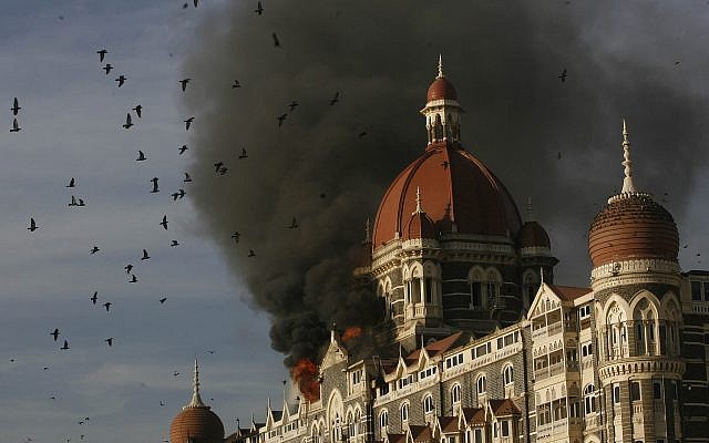 Pigeons fly as the Taj Hotel burns in Mumbai, India, Thursday, November 27, 2008.  (AP/Gautam Singh)
