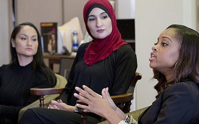 Tamika Mallory, right, co-chair of the Women's March on Washington, DC, talks during an interview with fellow co-chairs Carmen Perez, left, and Linda Sarsour, January 9, 2017, in New York City. (AP Photo/Mark Lennihan)