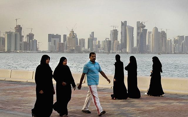 In this Saturday, April 7, 2012 file photo, the new high-rise buildings of downtown Doha, photographed in the background as Qatari women and a man walk by the sea in Doha, Qatar. (AP/Kamran Jebreili) In this Saturday, April 7, 2012 file photo, the new high-rise buildings of downtown Doha, photographed in the background as Qatari women and a man walk by the sea in Doha, Qatar. (AP/Kamran Jebreili)