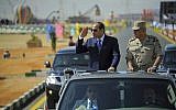 In this photo provided by Egypt's state news agency, MENA, Egyptian President Abdel-Fattah el-Sissi salutes as he inspects troops with Minister of Defense Sedki Sobhy, in the Red Sea port city of Suez, Egypt, Sunday, Oct. 29, 2017. (MENA via AP)