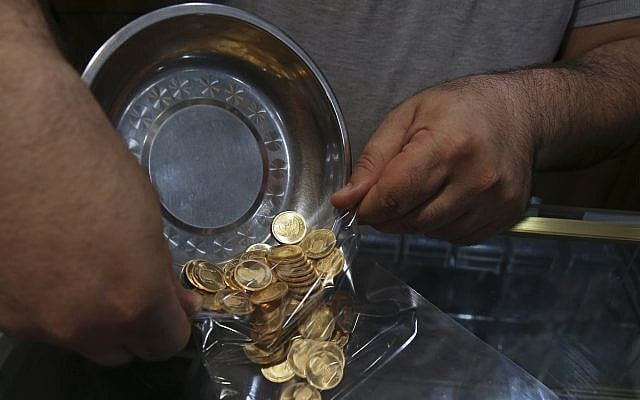 In this illustrative photo from August 12, 2018, an Iranian goldsmith counts gold coins at the sprawling Grand Bazaar in Tehran, Iran. (AP Photo/Vahid Salemi) In this illustrative photo from August 12, 2018, an Iranian goldsmith counts gold coins at the sprawling Grand Bazaar in Tehran, Iran. (AP Photo/Vahid Salemi)