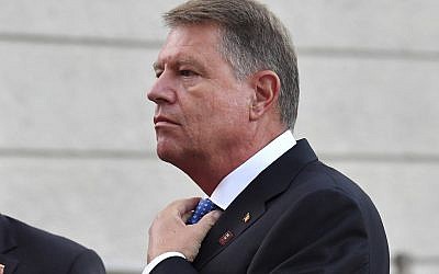 Romanian President Klaus Iohannis adjusts his tie when arriving at the informal EU summit in Salzburg, Austria, Wednesday, Sept. 19, 2018. (AP/Kerstin Joensson)