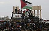 Illustrative: Protesters wave Palestinian flags while riding a truck full with tires near the fence of the Gaza Strip border with Israel during a protest east of Gaza City, Friday, October 26, 2018. (AP/Adel Hana)
