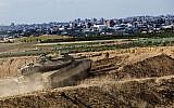 File: An Israeli tank takes a position at the Gaza Strip border, October 27, 2018.  (AP/Tsafrir Abayov)