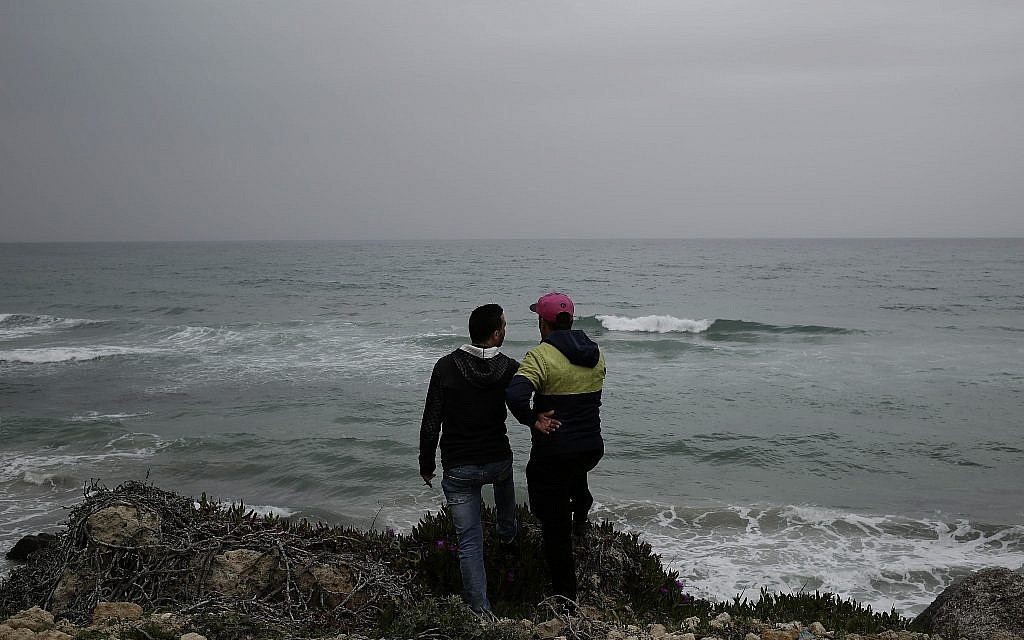 Ahmed Ayouby, 32, left, and Mounir Aguida, 30, who want to leave Tunisia, stand at the beach where migrants leave for Italy, in the town of Ras Jabal, Bizerte, Tunisia, on April 14, 2018. (AP Photo/Nariman El-Mofty)