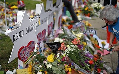 A woman visits a makeshift memorial  outside Tree of Life Synagogue in Pittsburgh, to the 11 people killed there during worship services, seen here on October 31, 2018. (Gene J. Puskar/ AP)