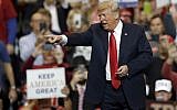 US President Donald Trump looks to the cheering crowd as he arrives to speak at a rally at Allen County War Memorial Coliseum, November 5, 2018, in Fort Wayne, Indiana (AP Photo/Carolyn Kaster)