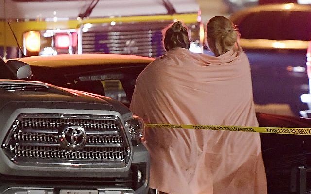 People walk away from the scene Thursday, Nov. 8, 2018, in Thousand Oaks, Calif. where a gunman opened fire Wednesday inside a country dance bar crowded with hundreds of people on 'college night' (AP Photo/Mark J. Terrill) People walk away from the scene Thursday, Nov. 8, 2018, in Thousand Oaks, Calif. where a gunman opened fire Wednesday inside a country dance bar crowded with hundreds of people on 'college night' (AP Photo/Mark J. Terrill)