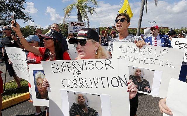 A crowd protests outside the Broward County Supervisor of Elections office Friday, Nov. 9, 2018, in Lauderhill, Fla. A possible recount looms in a tight Florida governor, Senate and agriculture commission race. (AP Photo/Joe Skipper) A crowd protests outside the Broward County Supervisor of Elections office Friday, Nov. 9, 2018, in Lauderhill, Fla. A possible recount looms in a tight Florida governor, Senate and agriculture commission race. (AP Photo/Joe Skipper)