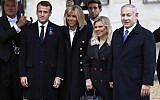 Prime Minister Benjamin Netanyahu, right, and his wife Sara, second right, are greeted by French President Emmanuel Macron, left, and his wife Brigitte Macron as they arrive at the Elysee Palace in Paris to participate in a World War I Commemoration Ceremony, November 11, 2018 (AP Photo/Christophe Ena)