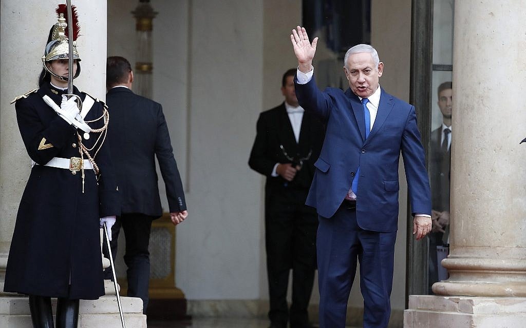 Prime Minister Benjamin Netanyahu waves, as he arrives at the Elysee Palace in Paris for a lunch after participating in a World War I commemoration ceremony, on November 11, 2018. (AP Photo/Christophe Ena) Prime Minister Benjamin Netanyahu waves, as he arrives at the Elysee Palace in Paris for a lunch after participating in a World War I commemoration ceremony, on November 11, 2018. (AP Photo/Christophe Ena)