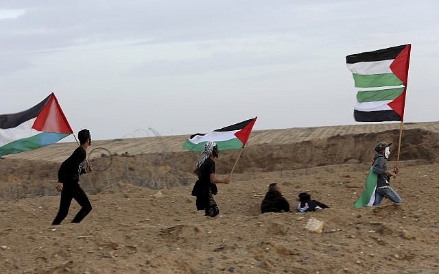 Protesters gather near the fence of the Gaza Strip border with Israel during a protest east of Gaza City, November 16, 2018. (AP/Adel Hana) Protesters gather near the fence of the Gaza Strip border with Israel during a protest east of Gaza City, November 16, 2018. (AP/Adel Hana)
