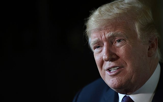 US President Donald Trump speaks to reporters following his teleconference with troops from his Mar-a-Lago estate in Palm Beach, Florida, November 22, 2018. (AP Photo/Susan Walsh)