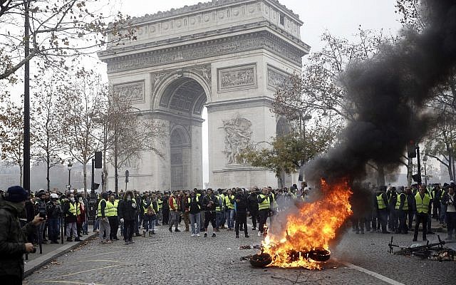 Demonstrators, called the yellow jackets, gather around the Arc de Triomphe as they protest against the fuel taxes, in Paris, France, Nov. 24, 2018 (AP Photo/Kamil Zihnioglu) Demonstrators, called the yellow jackets, gather around the Arc de Triomphe as they protest against the fuel taxes, in Paris, France, Nov. 24, 2018 (AP Photo/Kamil Zihnioglu)