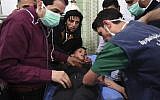 This photo released by the Syrian official news agency SANA, shows medical staff treating a boy following a suspected chemical attack on his town of al-Khalidiya, in Aleppo, Syria, Nov. 24, 2018 (SANA via AP)