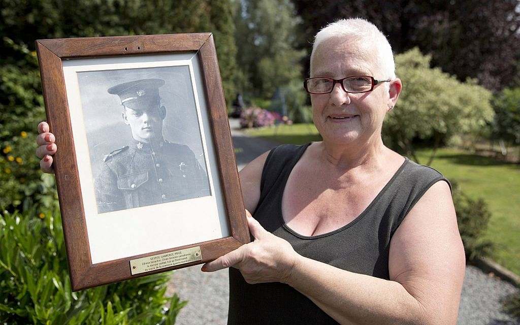 Resident Marilyn Lahaeu holds up a photo of World War I soldier Pvt. George Lawrence Price, who was killed in the Belgian village of Ville-sur-Haine, in 1918, near her home in Ville-sur-Haine, Belgium, Sunday, Aug. 3, 2014. (AP Photo/Virginia Mayo) Resident Marilyn Lahaeu holds up a photo of World War I soldier Pvt. George Lawrence Price, who was killed in the Belgian village of Ville-sur-Haine, in 1918, near her home in Ville-sur-Haine, Belgium, Sunday, Aug. 3, 2014. (AP Photo/Virginia Mayo)