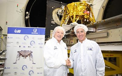 Canadian real estate mogul Sylvan Adams, right, with Morris Kahn, at Israel Aerospace Industries (IAI)’s MBT Space facility in Yehud where SpaceIL's spacecraft to the moon is being assembled (Eliran Avital)