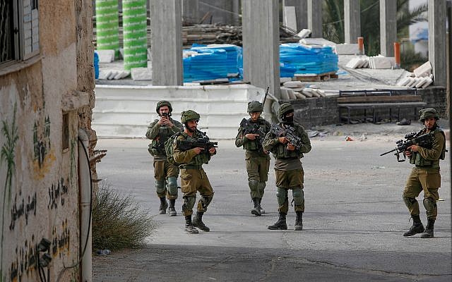 Israeli soldiers during a raid in the village of Shuweika, near the West Bank town of Tulkarem on October 20, 2018. (Nasser Ishtayeh/Flash90/File) Israeli soldiers during a raid in the village of Shuweika, near the West Bank town of Tulkarem on October 20, 2018. (Nasser Ishtayeh/Flash90/File)
