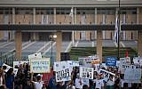 Israeli youth hold signs as they protest for a solution to Gaza border violence in front of the Knesset on November 8, 2018. (Yonatan Sindel/Flash90)