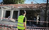 People gather outside a house that was hit by a rocket fired from the Gaza Strip in the southern Israeli city of Ashkelon, on November 13, 2018 (Hadas Parush/Flash90)