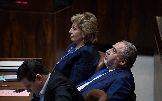 Leader of the Joint (Arab) List MK Ayman Odeh, left, former defense minister MK Avigdor Liberman, right, and former immigration minister Sofa Landver, background center, in the Knesset, November 19, 2018. (Hadas Parush/Flash90) Leader of the Joint (Arab) List MK Ayman Odeh, left, former defense minister MK Avigdor Liberman, right, and former immigration minister Sofa Landver, background center, in the Knesset, November 19, 2018. (Hadas Parush/Flash90)