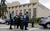 A Jewish emergency crew and police officers at the site of the mass shooting that killed 11 people and wounded 6, including 4 police, at the Tree of Life Synagogue on October 28, 2018, in Pittsburgh, Pennsylvania. (Jeff Swensen/Getty Images/via JTA)