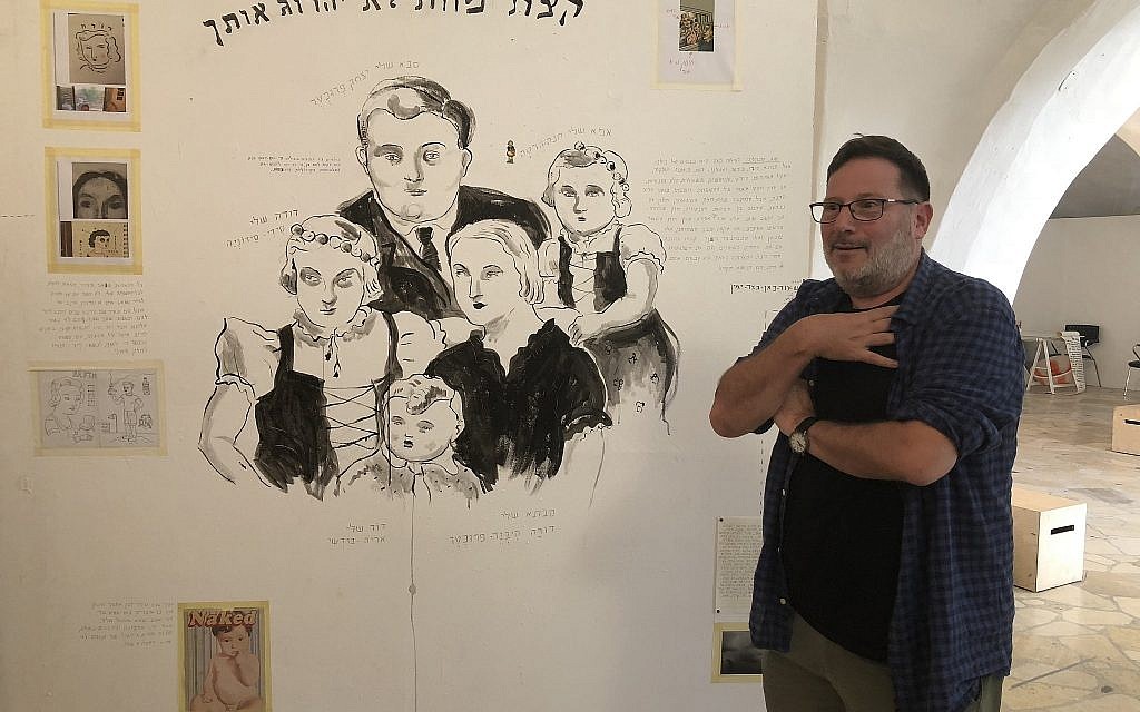Artist Itzik Rennert draws on family memories that aren't always sweet, at Illustration Week 2018 (Jessica Steinberg/Times of Israel)