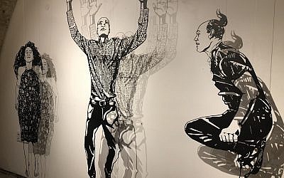 Michal Bachar's laser-cut figurines, creating shadow profiles in black and white, at Illustration Week 2018 (Jessica Steinberg/Times of Israel)