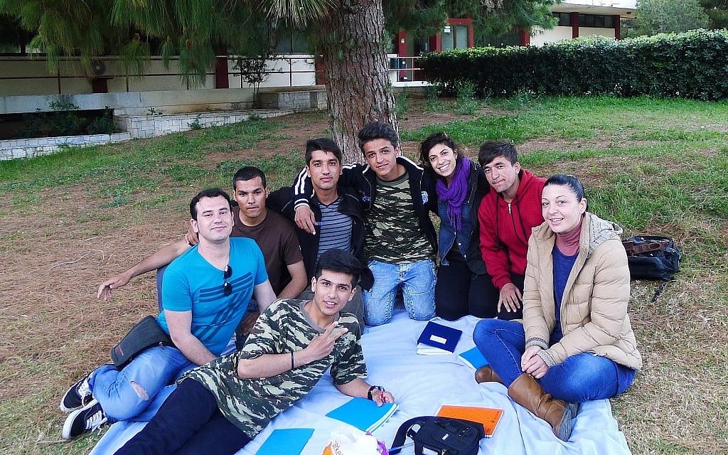 Hadas Yanay, center, outside the Elliniko refugee camp in Greece with her young Afghan language exchange students. (Courtesy)