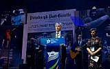 Rabbi Alvin Berkun, rabbi emeritus of The Tree of Life/Ohr Kodesh congregation in Pittsburgh, and Tzippy Holland, a Holocaust survivor, join at the Israeli American Council conference in a tribute to the police who stopped the massacre at a Pittsburgh synagogue, Nov. 29 2018. (IAC via JTA)