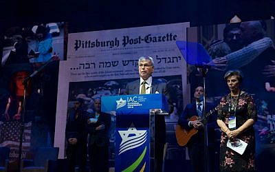 Rabbi Alvin Berkun, rabbi emeritus of The Tree of Life/Ohr Kodesh congregation in Pittsburgh, and Tzippy Holland, a Holocaust survivor, join at the Israeli American Council conference in a tribute to the police who stopped the massacre at a Pittsburgh synagogue, Nov. 29 2018. (IAC via JTA)