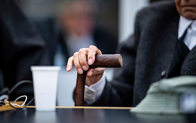 A 94-year-old former SS guard holds his walking stick at the beginning of a trial in Muenster, Germany, November 6, 2018. He is charged with accessory to murder for serving at the Nazis' Stutthof concentration camp. (Guido Kirchner/dpa via AP)