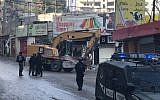 Police accompany bulldozers demolishing storefronts in the Shuafat Refugee Camp in East Jerusalem, November 21, 2018. (Courtesy Ir Amim)