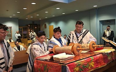 Lior Barron, second from left, and Phillip Nussbaum, third from left, celebrate their recent b’nai mitzvah at Zichron Yisroel with Mike Walden and Keith Zauder. (Zichron Yisroel/via JTA)
