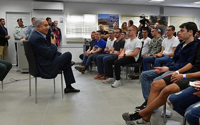Prime Minister Benjamin Netanyahu speaks to a group of new recruits at the army's Tel HaShomer induction center outside of Tel Aviv on November 26, 2018. (Ariel Hermoni/Defense Ministry) Prime Minister Benjamin Netanyahu speaks to a group of new recruits at the army's Tel HaShomer induction center outside of Tel Aviv on November 26, 2018. (Ariel Hermoni/Defense Ministry)