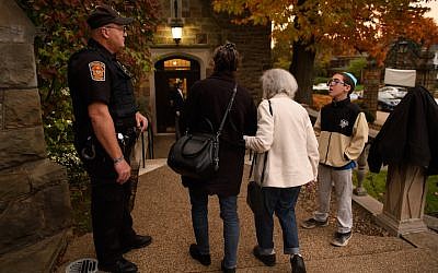 A police officer stands guard outside Temple Sinai before Friday evening Shabbat services on November 2, 2018 in Pittsburgh, Pennsylvania. Temple Sinai, just a half mile from Tree of Life Synagogue, opened their doors to Pittsburgh-area Jews and people of all faiths in the wake of the mass shooting that left 11 people dead at the Tree of Life on October 27, 2018.(Photo by Jeff Swensen/Getty Images via JTA)