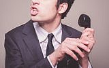 Illustrative photo of a phone scammer (Photo credit: lolostock/iStock)