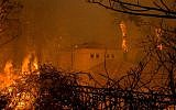 Flames surround a house in Malibu, California, on November 9, 2018, part of the Woolsey fire that has led to the evacuation of about 75,000 homes in southern California. (David McNew/ Getty Images)