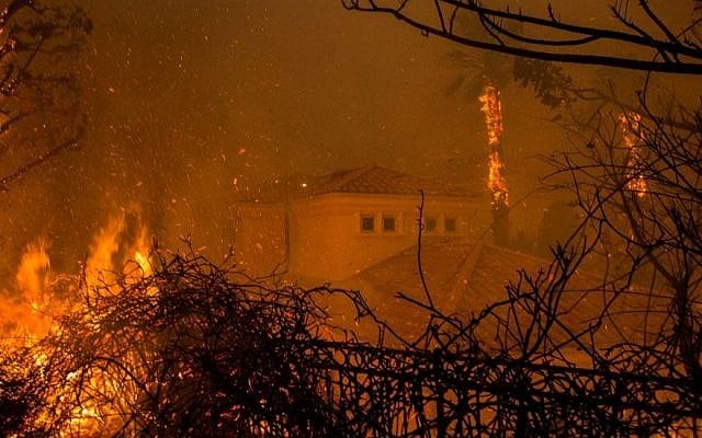 Flames surround a house in Malibu, California, on November 9, 2018, part of the Woolsey fire that has led to the evacuation of about 75,000 homes in southern California. (David McNew/ Getty Images) Flames surround a house in Malibu, California, on November 9, 2018, part of the Woolsey fire that has led to the evacuation of about 75,000 homes in southern California. (David McNew/ Getty Images)