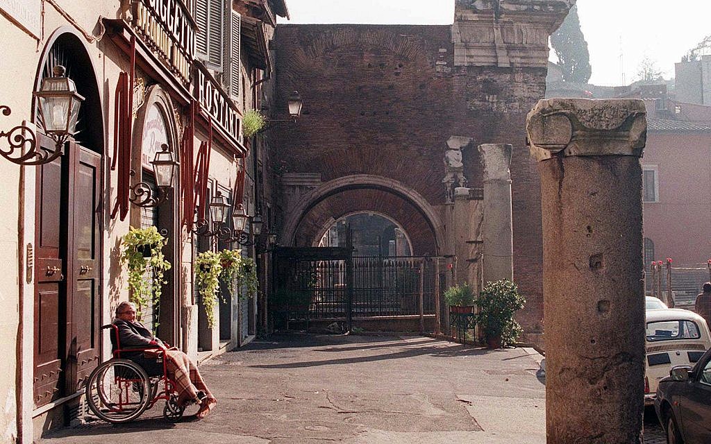 Illustrative: A woman in a wheelchair basks in the sun on Via Portico d'Ottavia in Rome's Old Ghetto, one of the world's longest continuing Jewish communities, October 31, 1997. (AP Photo/Andrew Medichini)