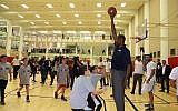 Ex-NBA star Dikembe Mutombo inaugurates a YMCA sports center in Jerusalem on November 27, 2018 (Courtesy)