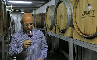 Omar Zumot, who studied winemaking in France, samples a wine inside the Saint George winery in Zahab, an eastern suburb of Amman, Jordan, on November 5, 2018. (Laure van Ruymbeke/AFP)