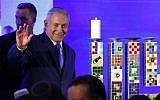 Prime Minister Benjamin Netanyahu waves before lighting a stylized-candle during the start of Hanukkah, the Jewish festival of lights, in Ramat Gan in the suburbs of the Mediterranean coastal city of Tel Aviv on December 2, 2018. (Jack GUEZ / AFP)