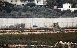 Israeli soldiers standing by excavation machinery near the border wall with Lebanon in the area of Metulla, December 4, 2018.(JALAA MAREY/AFP)