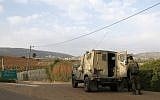 This picture taken on December 4, 2018 near the northern Israeli town of Metula, shows Israeli soldiers standing outside a military vehicle near the border with Lebanon. (JALAA MAREY / AFP)