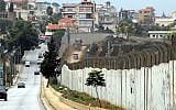 A view of the border with Israel, from the southern Lebanese village of Kafr Kila, with Israeli vehicles driving on the right side and UN and Lebanese vehicles driving on the left, on December 4, 2018. (Ali Dia/AFP)