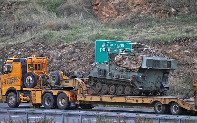 An Israeli armored personnel carrier and command post is transported toward the border with Lebanon on December 4, 2018. (JALAA MAREY / AFP) An Israeli armored personnel carrier and command post is transported toward the border with Lebanon on December 4, 2018. (JALAA MAREY / AFP)