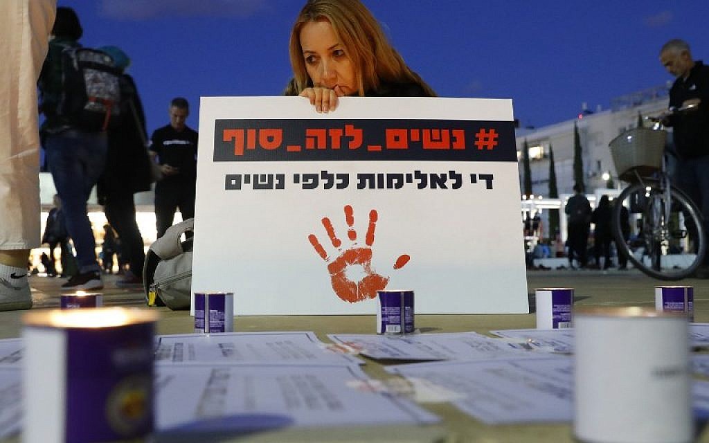 A woman holds a placard which reads in Hebrew "Stop the violence against women" during a rally against domestic violence in Tel Aviv on December 4, 2018. (Photo by JACK GUEZ / AFP)