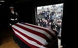 The flag-draped casket of former US President George H. W. Bush passes through Magnolia, Texas, on December 6, 2018, along the route from Spring to College Station, Texas. (AFP/David J. Phillip/Pool)