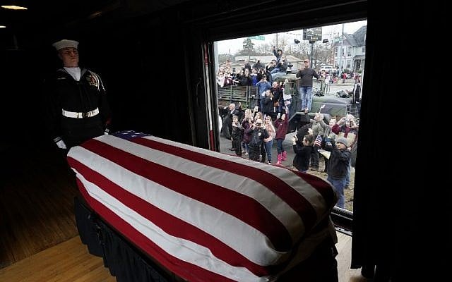 The flag-draped casket of former US President George H. W. Bush passes through Magnolia, Texas, on December 6, 2018, along the route from Spring to College Station, Texas. (AFP/David J. Phillip/Pool) The flag-draped casket of former US President George H. W. Bush passes through Magnolia, Texas, on December 6, 2018, along the route from Spring to College Station, Texas. (AFP/David J. Phillip/Pool)